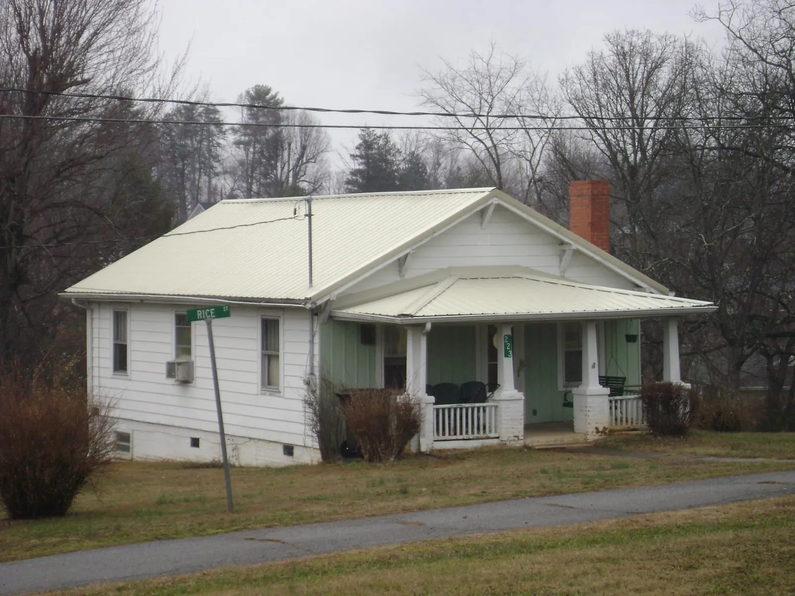 White metal roof on a craftsman bungalow at a street corner in Grayling